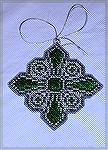 Ornament by Alana Beyea from our 2002 Holiday Ornament Swap.  This is a cross from a portrait of young Henry VII of England, who wore it on a chain around his neck.  Pattern from "Historic Crosses" pa