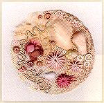 A small stumpwork panel made by myself. The pebbles are made in leather or hand dyed silk the threads used for the rest of the work were either silk or cotton, hand dyed. The Limpets were worked over 