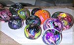 Paperweights made in a class at Weisser 
Stained Glass in Kensington Maryland.
We used the glory hole method, rather
than the blown glass method.  My 
paperweights are the pink/purple one 
on the