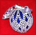 This ornament was done by Kyra Tenpenny using her home embroidery machine and a Criswell lace Christmas ornament cover. The cover was placed over a transparent blue glass ornament.

2001 Ornament Sw