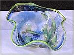 Your basic glass floppy bowl with yellow and blue highlights. ~7 inches across and 4 inches tall.