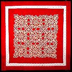 Square doily tatted by Kathy Morgret and stitched to fabric to make a quilt block.  Block assembled by Becky Craft.  This was one of several blocks contributed by the Fibercrafts forum to the Autism A