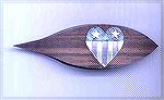 New tatting shuttle by David Reed Smith, with an inlaid heart with a flag theme. The stripes on the bottom are brass and aluminum.  The blue background on top of the heart is blue spruce Corian.  The 