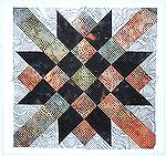 Railroad Crossing, a nine patch quilt block, made of two batiks and a printed cotton.   There is a new one each month.  Please join us. Directions to the website are on our home page.

March Qcister