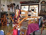 This shows the Baby Wolf and Magic Dobby, looking back towards the main part of the house. You can see my Schacht wheel and my skeinwinder attached to the counter - I have a deep double sink there. It