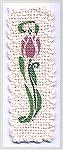 Bookmark base is done in ecru "kitchen" cotton on Weavette Bookmark loom with stenciled flower design.   Stenciled Weavette BookmarkDonann Remund