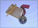 Sue Sommerville's ornament in our 2002 ornament swap.  A brass bell decorated with assorted beads, with a little chiffon bag.Sue Sommerville's ornament 2002ChristinaNorton