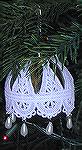 Ornament by Kyra Tenpenny for our 2002 Holiday Ornament Swap.  (This photo does not do this ornament justice!) On the inside of a clear glass ornament Kyra used red, gold, and black acrylic paint.  Th