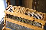 This is a shot of the top of the Woolhouse Mimi loom, showing the staggered levers used to raise the shafts.Woolhouse Mimi leversDeanna Johnson