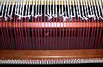 This is a close-up of the way to lace a warp onto the front beam at the start of weaving.  This way of tying the warp onto the front of the loom makes it very easy to adjust tension across the width o
