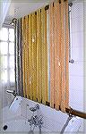 This is a minimalist approach to blocking yarns!  It's two bamboo rods:  one is suspended from the ceiling, the other is supported by the lower ends of the drying skeins.  The lower rod can be weighte