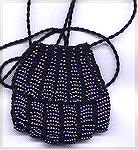 This is my first beaded knitted bag, knit from #8 perle coton and using beads from a hank...  designed by Theresda Williams, as printed in her book Bead Knitted Pendant Bags.
