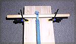 This is the anchoring system I used at the start of the warp in my tablet-weaving setup.  (Simple, eh?)