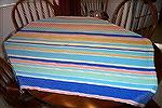 Full view of tablecloth woven by Ramona Abernathy-Paine. Fibinacci numbers used to determine stripe width and spacing. Colors come from Fiesta Ware. Woven of Orlec.