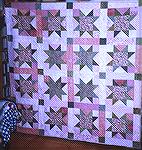 This quilt was made as part of my efforts to reduce my stash a little (hasn't worked so far). I picked the colours from the tulip fabric in the middle of the outer stars. This quilt was given to a fri