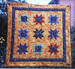 This quilt was made with the pack of challenge fabric purchased from my local quilt shop last year. The feature fabric was used in the centre of the stars and more in the border and the co-ordinating 