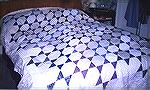 This quilt was made for my aunt and uncle's ruby wedding anniversary. They requested a quilt with blues and purples and as their bedroom is quite dark I made this quilt predominantly with neutrals and