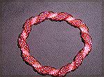 Beaded crocheted bracelet made from a round of six, three #11 seed beads and three #8 seed beads.