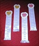 Bookmarks submitted by Becky Morgan in our 2004 Beverly Marchetti Bookmarks for Literacy Swap.  Becky's own design, with crocheted thread hearts and satin ribbon.