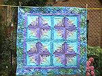 This is my wallhanging made with the Patchworks fabric challenge pack for 2004. It's a foundation pieced crazy log cabin block more heavily quilted than anything else I've made before