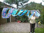 Here is Ans with our morning's work:  colourful shibori scarves, fluttering in the wind and gleaming brightly each time a sunbeam shot through between the clouds.