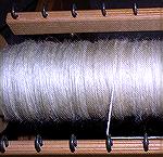 This is the worsted yarn on the bobbin, spun from combed Wensleydale fleece.  The variations of colour you can see in the yarn come from variations in the oil formula I used during combing.