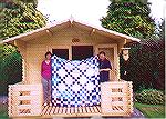 This is a photo of Marie-Louise Mundie and Catriona Stirling holding M-L's quilt made by members of this forum. 