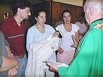 This is the christening gown I knit this spring for my new baby, Miss Bugtussle, better known as Taina Leah.  This picture was taken during her Baptism, with Mom, Dad on the left, and her Godmother, L