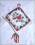 Karen Willett's holiday ornament is a cross-stitched bird from a Mill Hill kit, using DMC floss and beads.  From our 2004 Holiday Ornament Swap.
