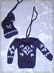 This little knitted outfit is by Alana Beyea. She found the pattern at www.knitting.about.com in their holiday section.  It is by Rosa Urban Lang of Romania, who got it from her grandmother.  From our