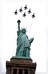 This is a picture of the Air Force Thunderbirds flying over the Statue of Liberty.