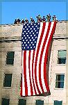 This is a picture of workers hanging the flag on the Pentagon shortly after an aircraft flew into it on Sept 11, 2001.