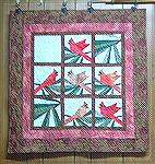 This is my second try at paper piecing. I made the one and one other as a Christmas gift for a friend. I quilted it on my NewJoy frame with a pattern called fractured.

Kyra Tenpenny