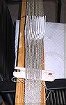 This is the starting position in tablet weaving, shown from the weaver's point of view.
