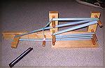 This inkle loom was created by my Dad and me, following the plans in Helene Bress' book, &quot;Inkle Weaving&quot;.  As you can see, it works very well.  :-)

(P.S. - If you make one for yourself, b