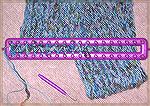 This scarf (which is folded back on itself underneath the knitting loom) was peg-knit on a "Knifty Knitter" knitting frame.  Note how winding the yarn around the pegs this way twists all the stitches.