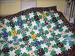 I made two football (soccer) quilts for my nephews for Christmas. As they both support the same team that has a green and white strip, one got a quilt with green sashing and white stars and the other 