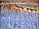 This napkin is being woven on a crackle threading.

Warp: 10/2 cotton, natural.
Weft: 20/2 cotton, dyed navy by me, used doubled.

