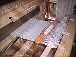 This is the project-in-progress at Ans' house!  The loom is a Megado, the shuttle is a Flying Dutchman, and the warp is mohair boucl&#233;.
