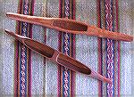 This is a photo of completely unrelated items.

The two shuttles are silk shuttles from Laos.  The double shuttle is lightweight and very finely made; the single shuttle is made from a heavy wood an