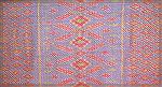 This throw is made of handspun silk, its color patterning coming from weft ikat, its texture coming from the diamond shapes of a &quot;goose-eye&quot; twill.