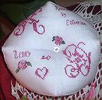 this is the bottom side of the pincushion...with intials for the person it was going to, and Remember 2006, my name, and Legacy for the board where the exchange was organized. The hearts are done over