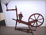 This red spinning wheel came from an eBay seller in southern Holland, who says its style makes her think of wheels from Flanders.

It is a small wheel with double drive and a tow distaff, excellent 