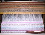 This plainweave towel is part of an effort to tidy my living area &lt;G>.

The warp is 10/2 mercerized cotton, threaded in crackle; the wefts are 22/2 cottolin (the beige part), handspun heavy tow l