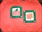 This is a picture of changeable panels I made for sweatshirts. They were sewn in my largest embroidery hoop so no hand sewing was needed.

Kyra