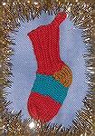 This happy little stocking was designed and knitted by Micki McCrillis for the 2008 Ornament Swap. This is Micki's stocking to be filled by Santa. This is Micki's own toe-up, short row toe and head so