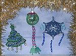 These ornaments were made by Patricia Tenpenny for the 2008 Ornament Swap. The glass ornament is her own design. The tree and the blue snowflake are from a Christmas collection by Dakota and the she a