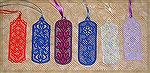 Bookmarks donated by Kyra Tenpenny. The bookmarks were machine embroidered. They are by http://www.oregonpatchworks.com under embroidery collections Ace Point Designs.