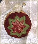 This quilted ornament was done by Kyra Tenpenny using a styrofoam ball 2 1/2" squares of fabric and straight pins. With a little ribbon to finish it with.