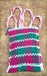 This ornament was woven by Tony Burg. It was woven as a tube in double weave. The bottom was hem stitched with a fringe. The Top was rolled in and hemmed. The loop was made seperately using a 3 clip t